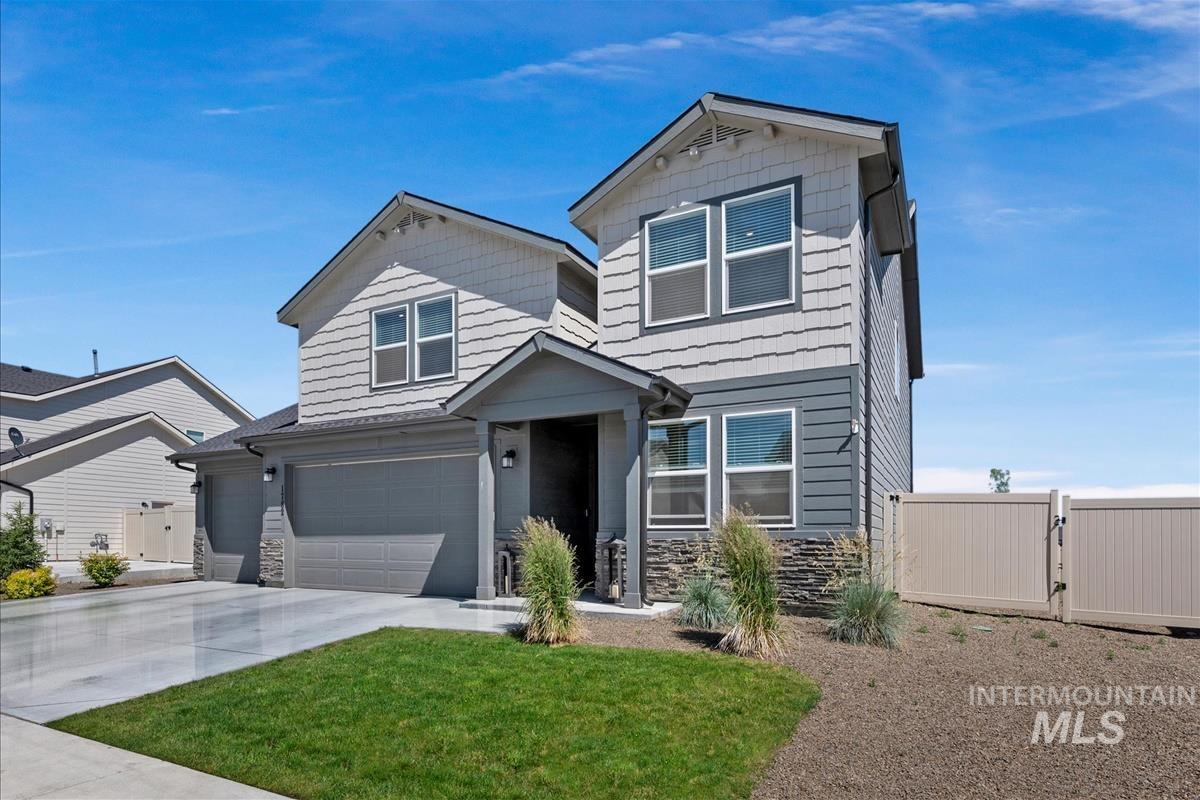 Contemporary two-story exterior featuring a gray and light gray siding combination with stone accents