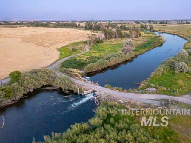 Aerial view of property and surrounding area featuring a large body of water and rural landscape