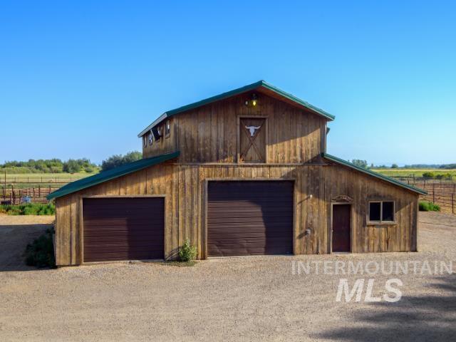 Garage featuring a garage and a rural view