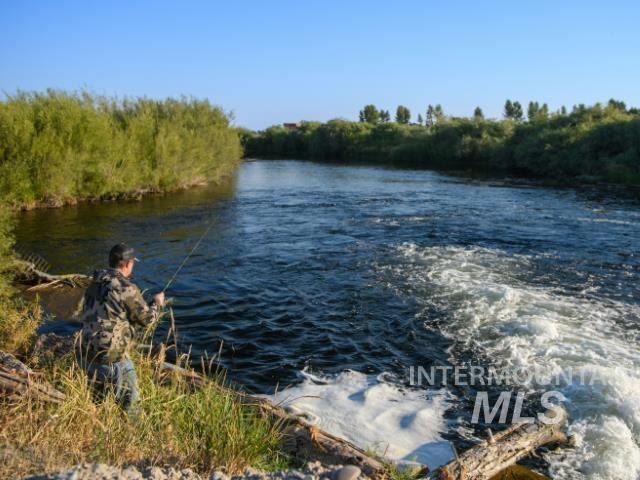 Water view with a heavily wooded area