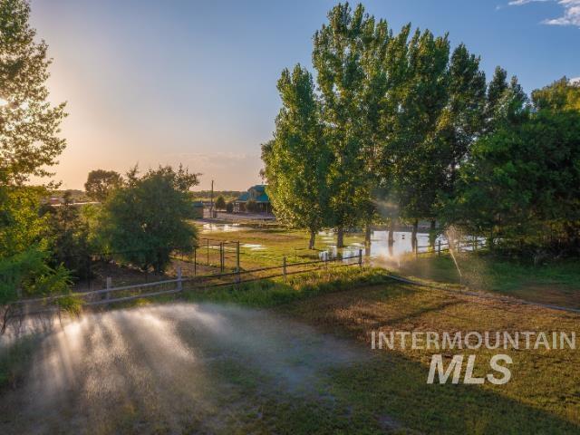 Yard at dusk with a view of rural / pastoral area