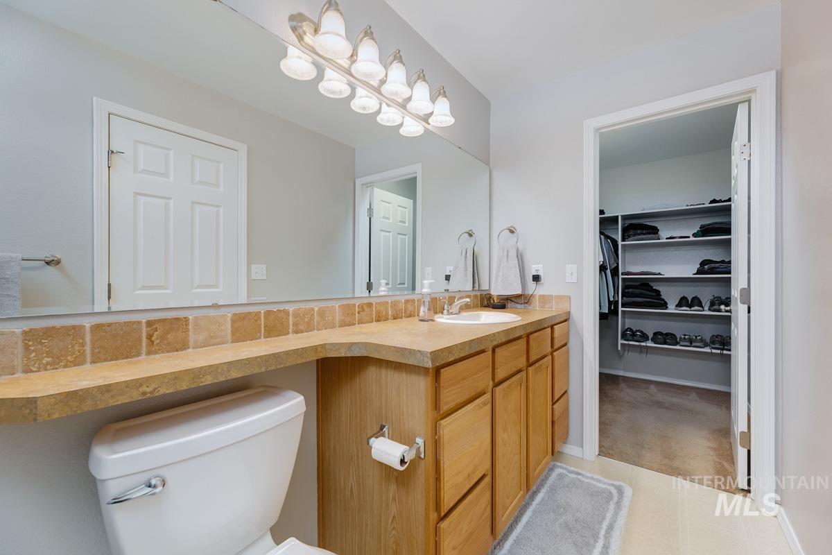 Bathroom featuring vanity and a spacious closet
