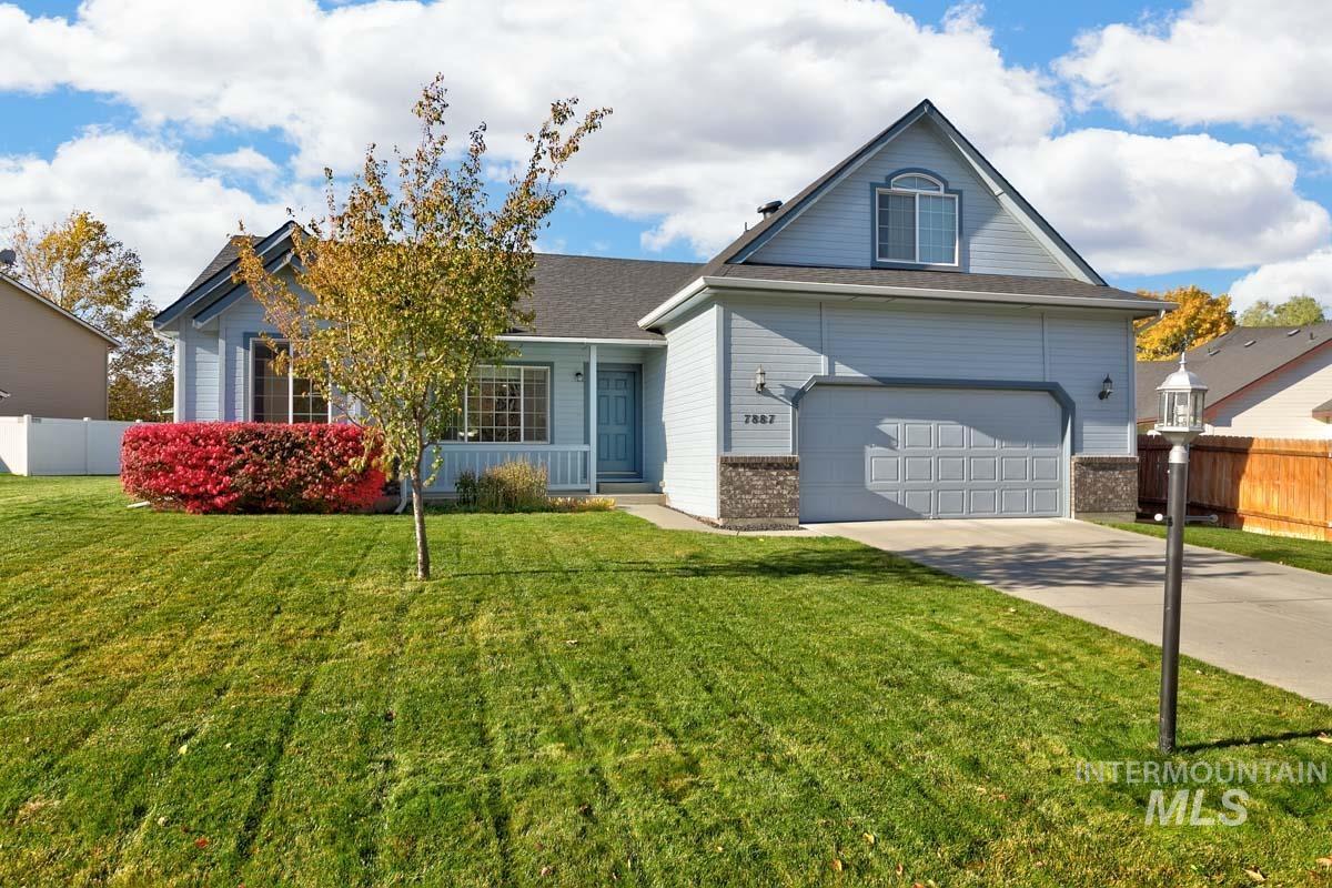 View of front of home with brick siding, driveway, and an attached garage