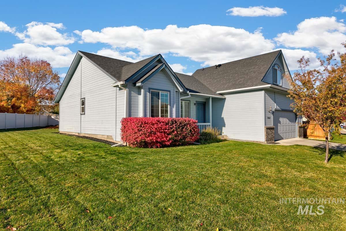 View of side of property with a garage, roof with shingles, and concrete driveway