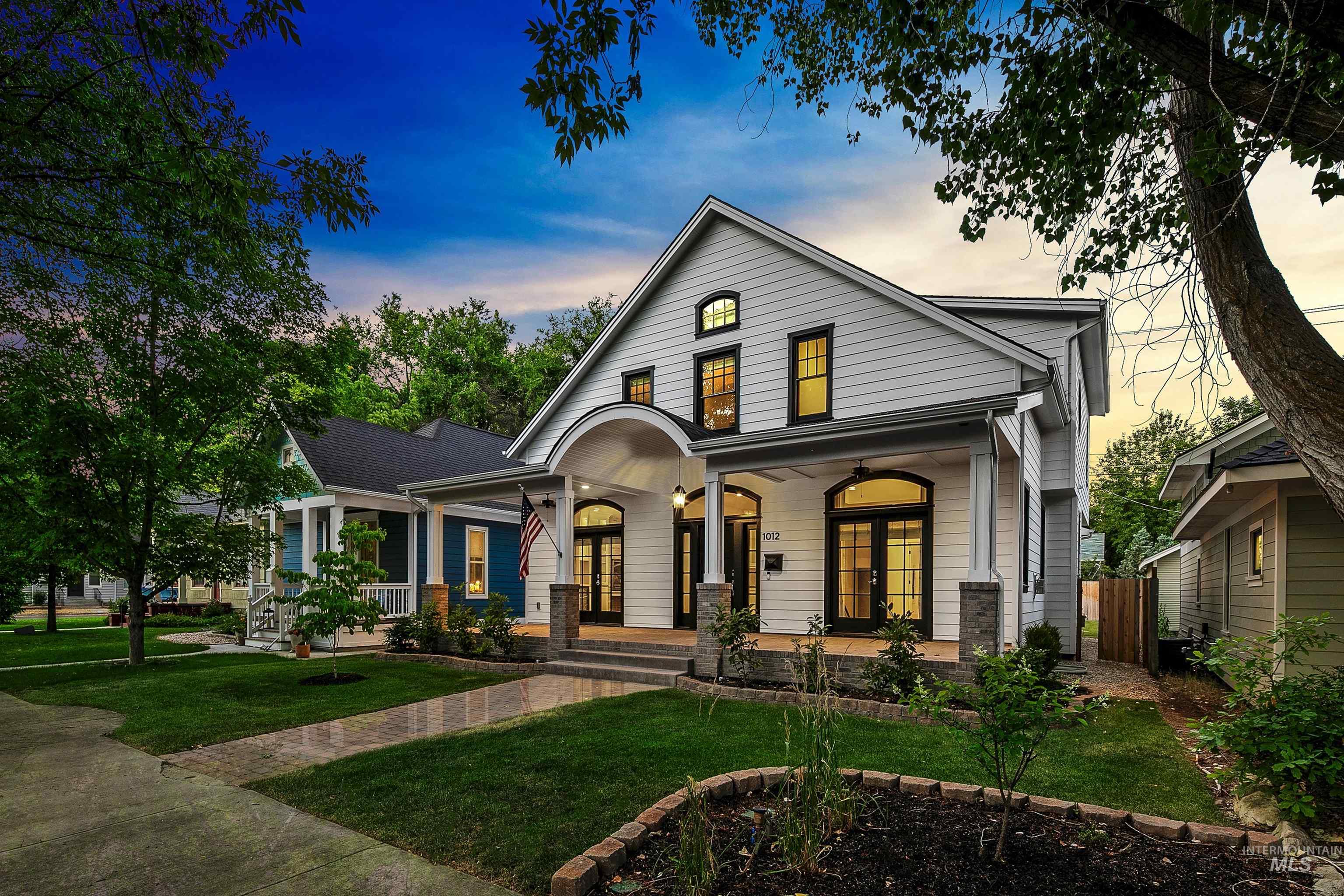 View of front of home featuring covered porch, a lawn, and french doors