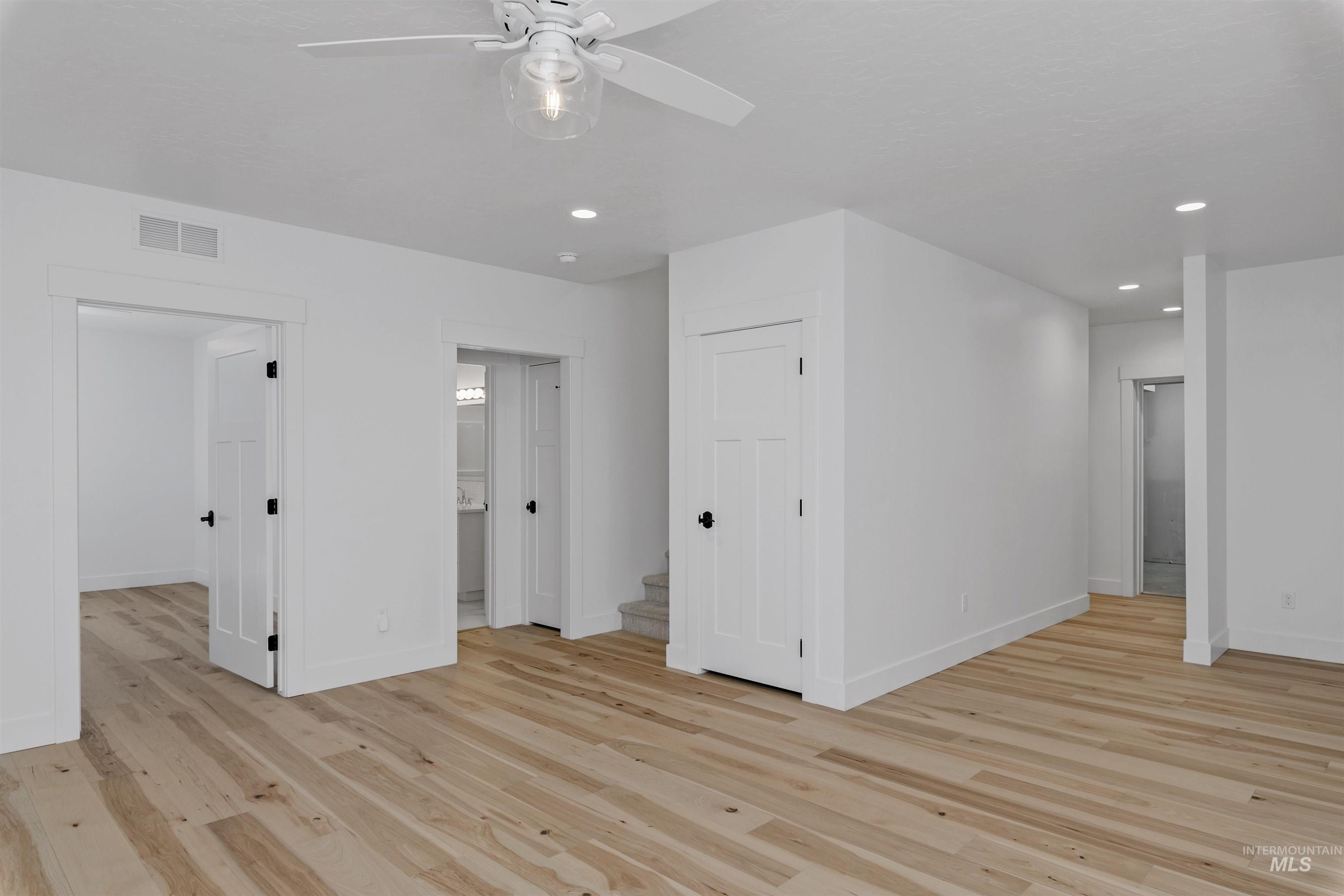 Unfurnished living room featuring light wood-style flooring, recessed lighting, and a ceiling fan