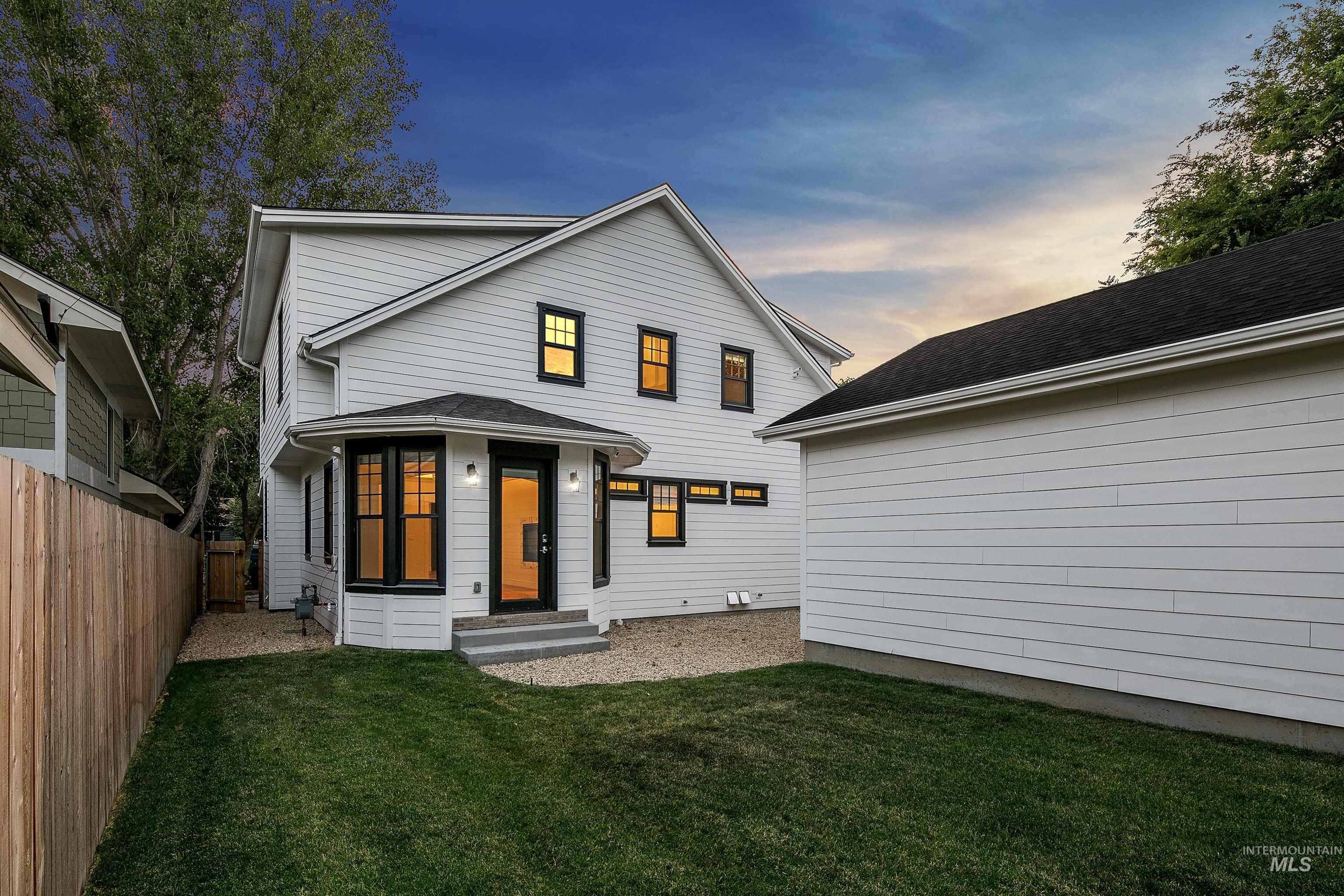 Back of house featuring a shingled roof