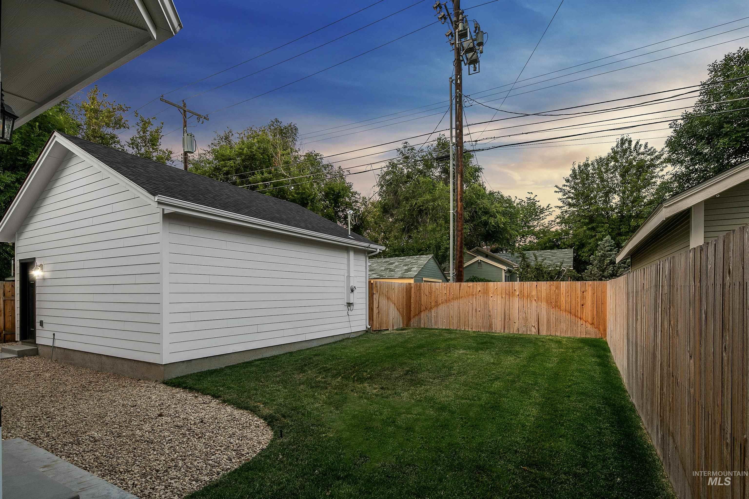 Yard at dusk featuring a fenced backyard