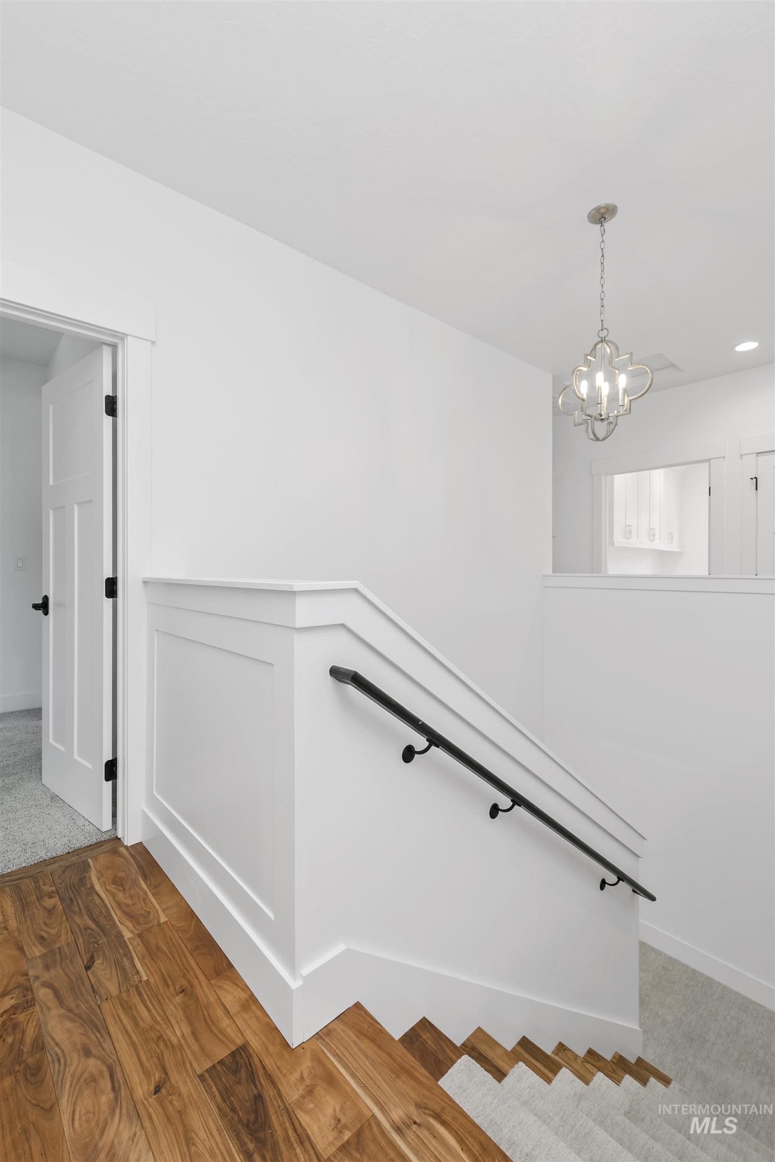Staircase featuring a chandelier, carpet flooring, and recessed lighting