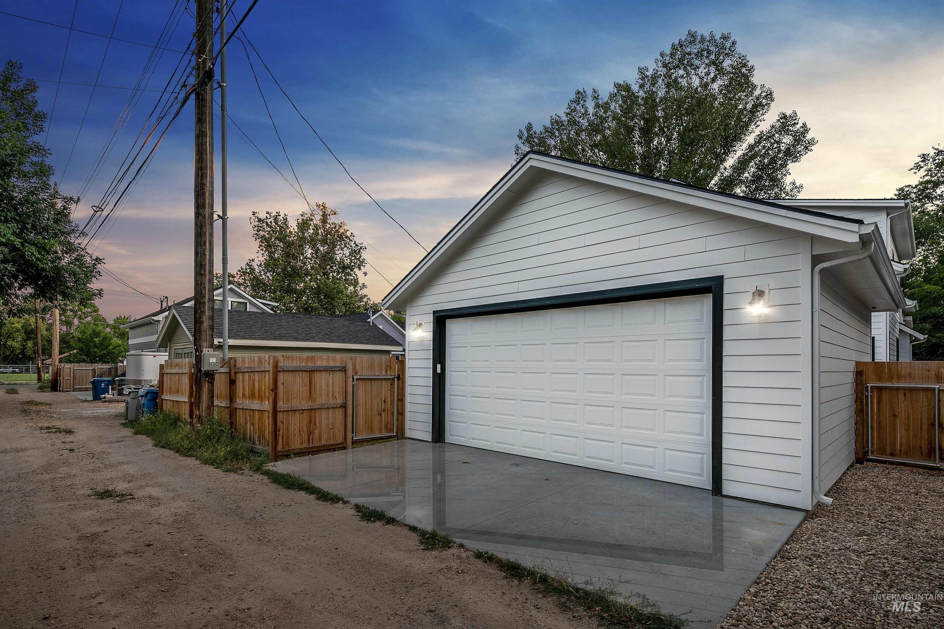 Garage at dusk with a detached garage