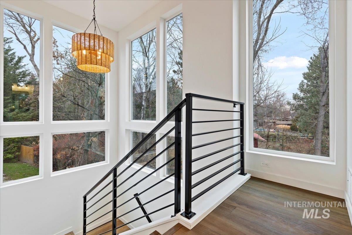 Staircase featuring wood finished floors and baseboards
