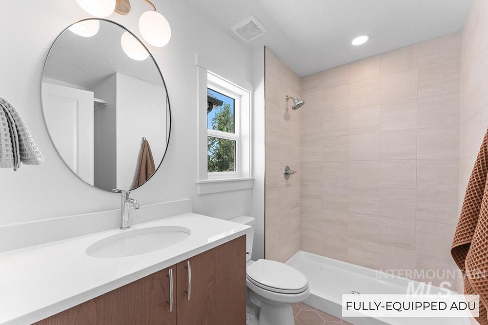 Bathroom featuring vanity and a tile shower