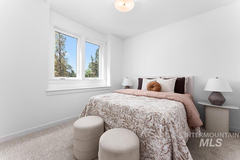Carpeted bedroom with baseboards
