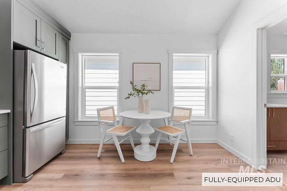 Dining area featuring light wood-style floors and baseboards