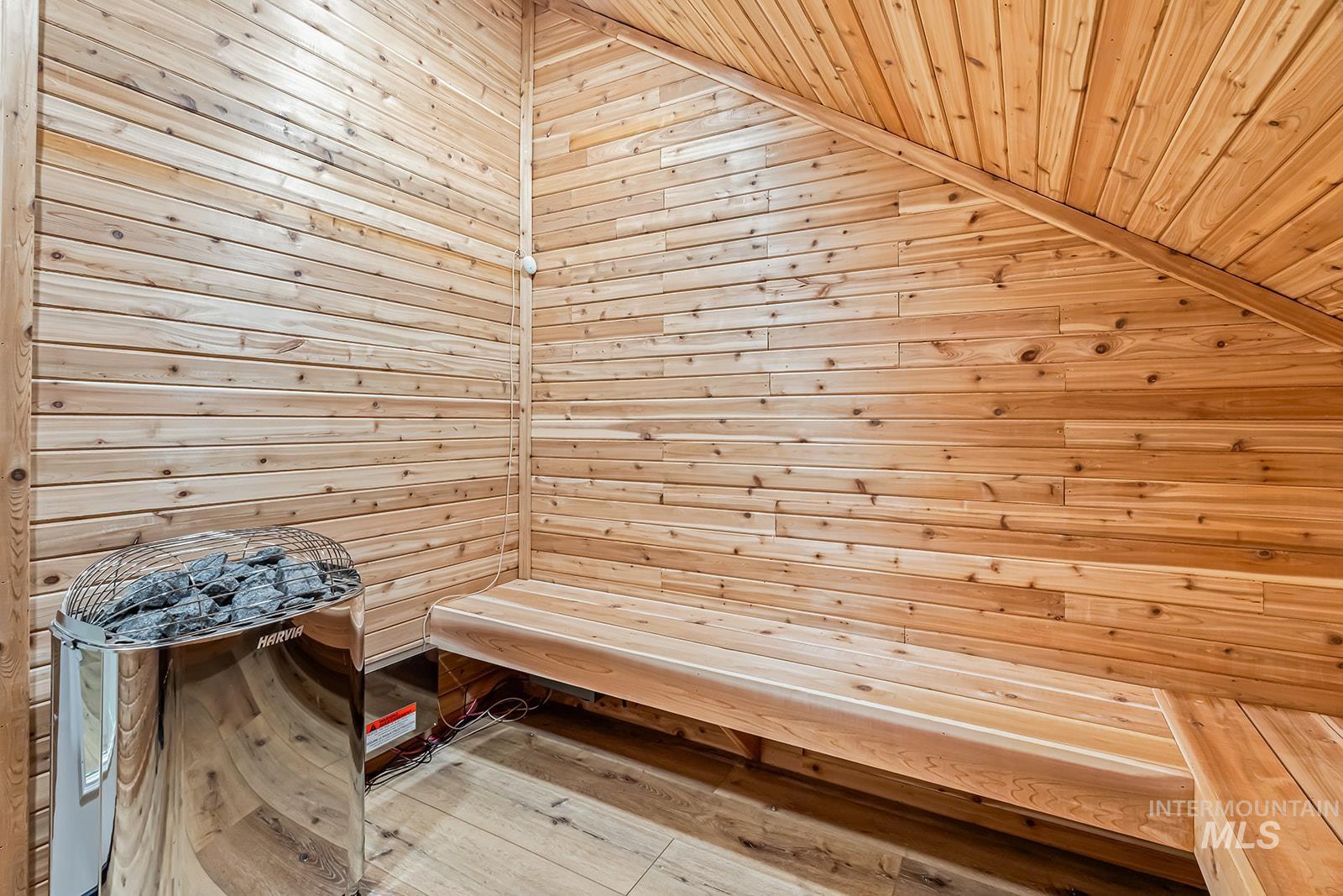 Relaxing sauna / steam room featuring wooden walls