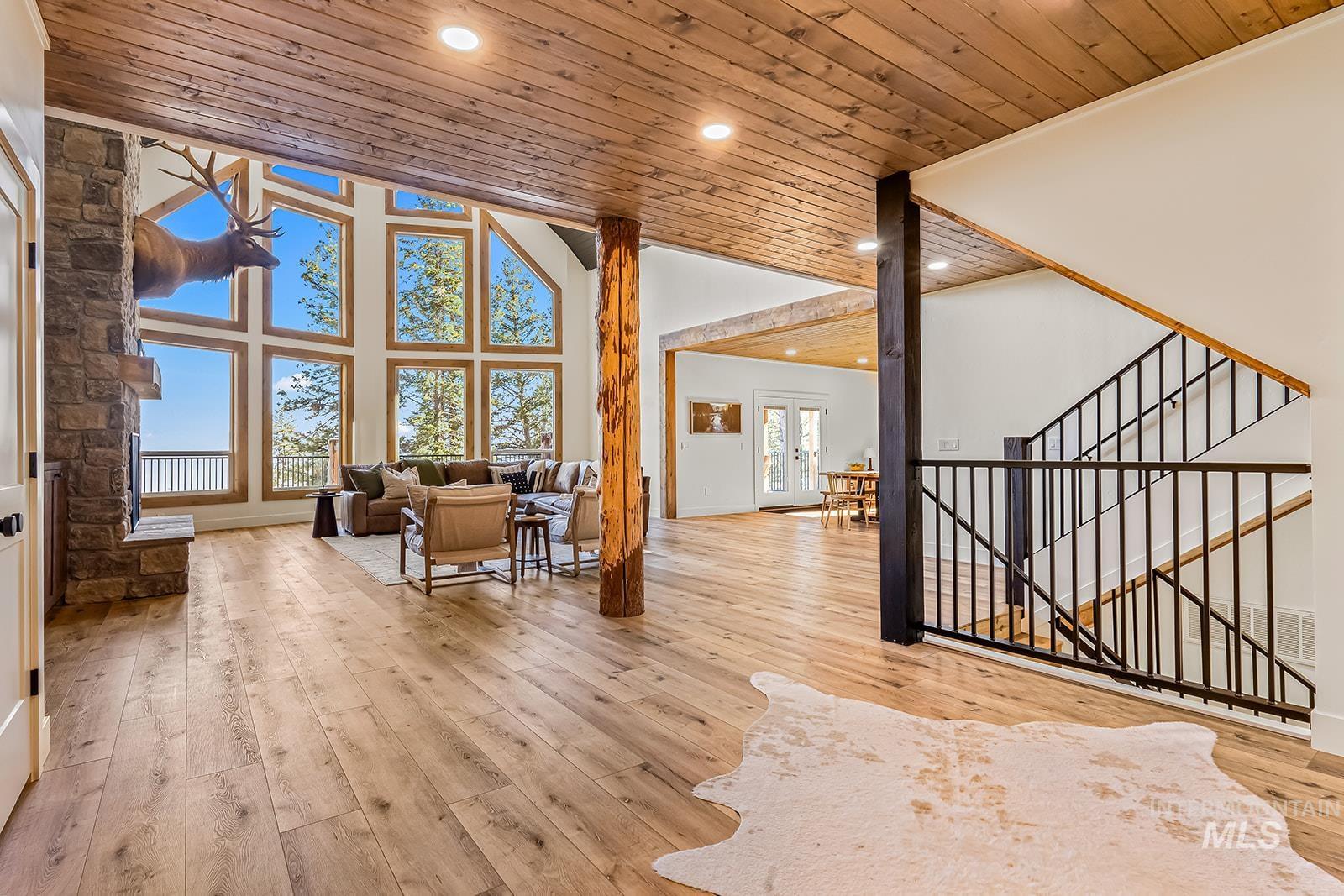 Living room featuring light wood-style floors, a vaulted wood ceiling, recessed lighting, and french doors