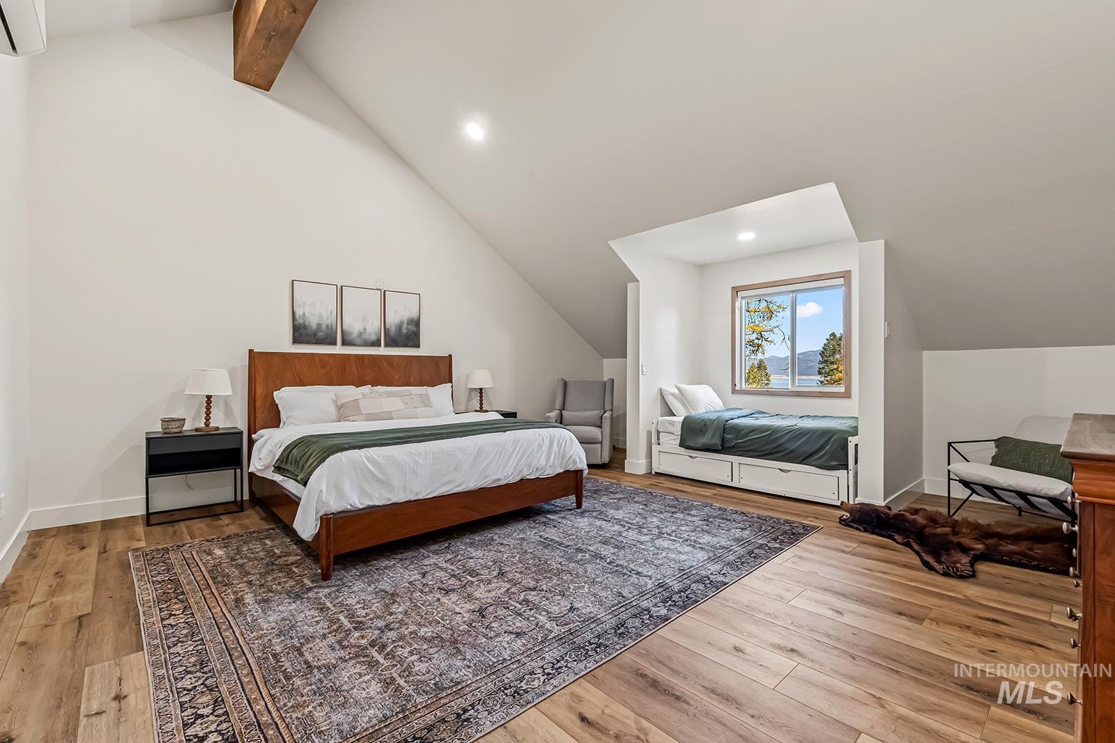 Bedroom with vaulted ceiling with beams, light wood finished floors, and recessed lighting