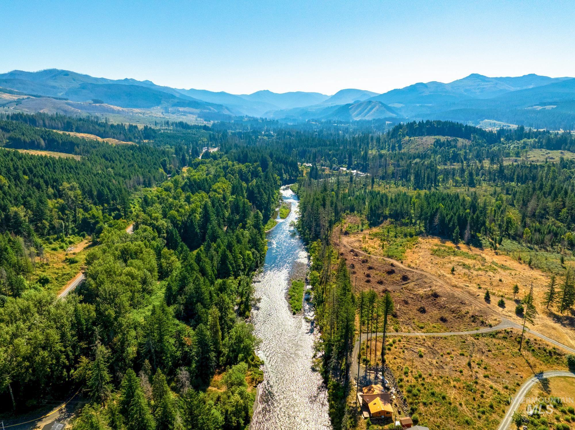 Bird's eye view of a water and mountain view and a heavily wooded area