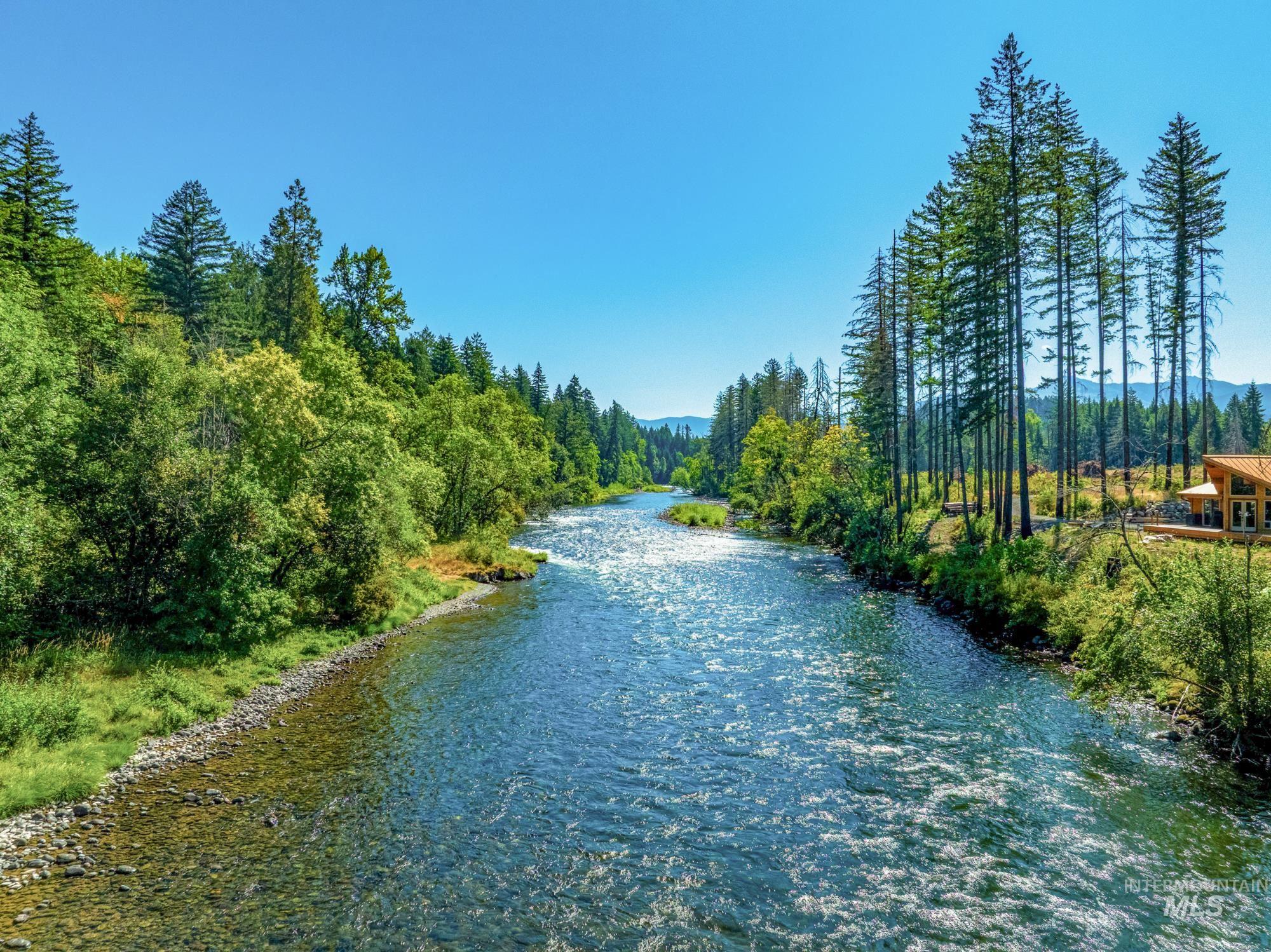 Water view with a heavily wooded area