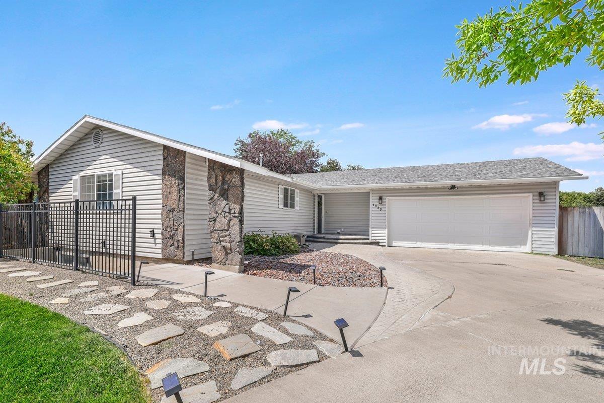 Ranch-style house featuring an attached garage and concrete driveway