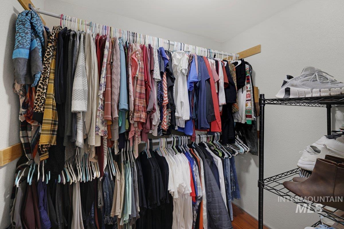 Walk in closet featuring wood finished floors