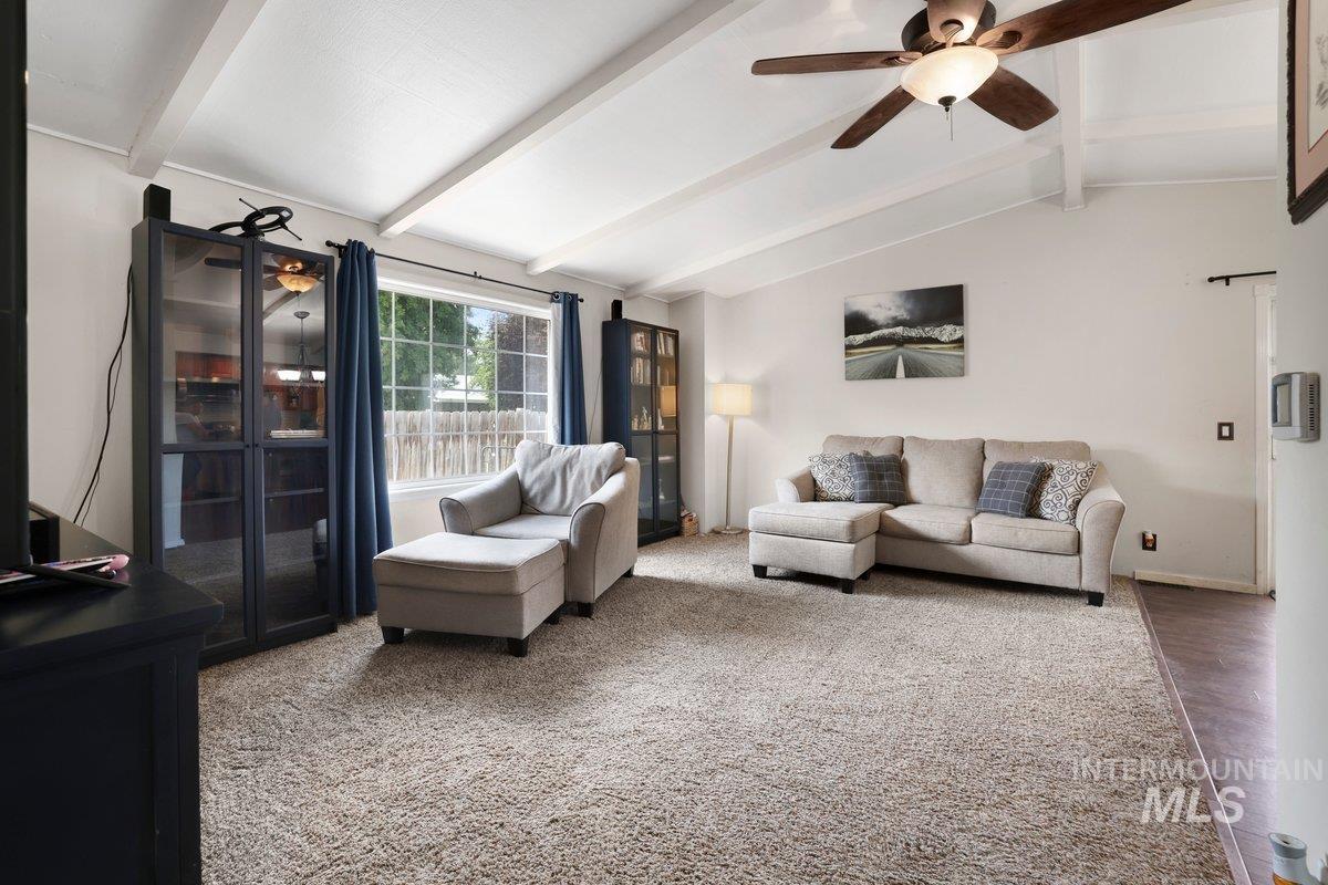 Living room featuring ceiling fan and wood finished floors