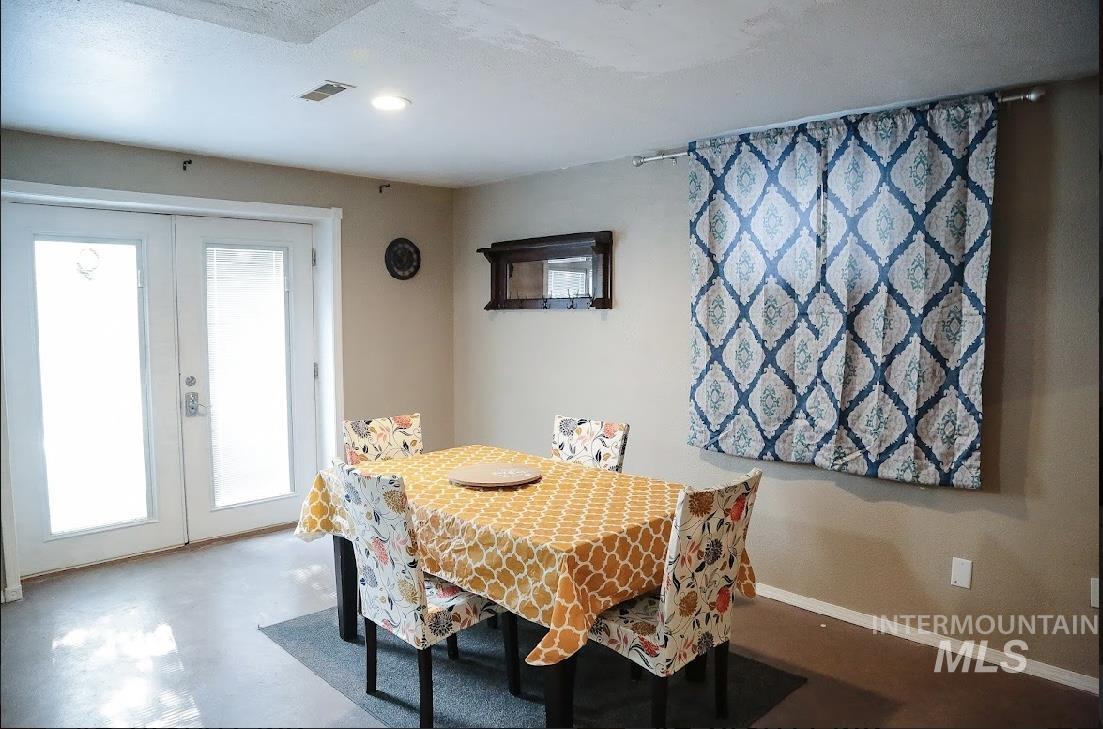Dining area with french doors and recessed lighting
