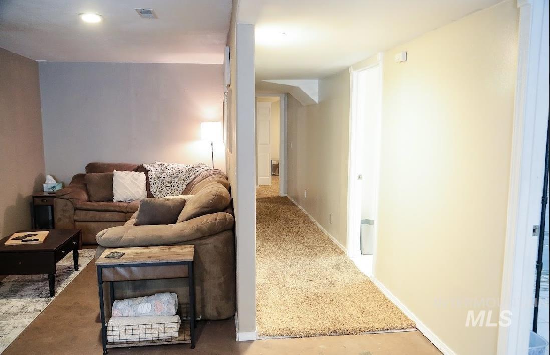 Carpeted living area with baseboards