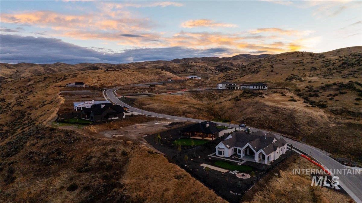 Aerial view of property's location featuring a mountainous background