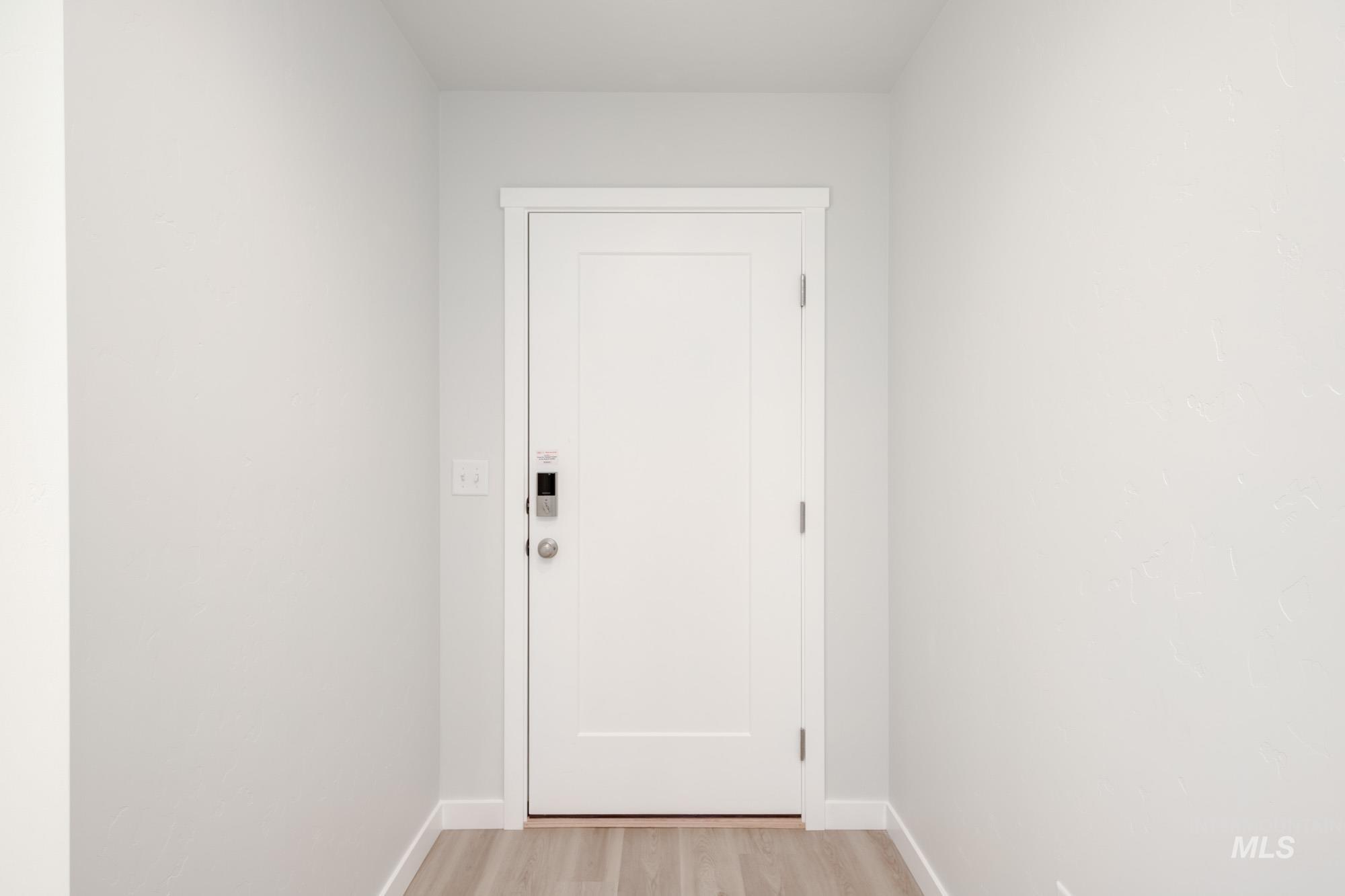 Entryway featuring wood finished floors and baseboards
