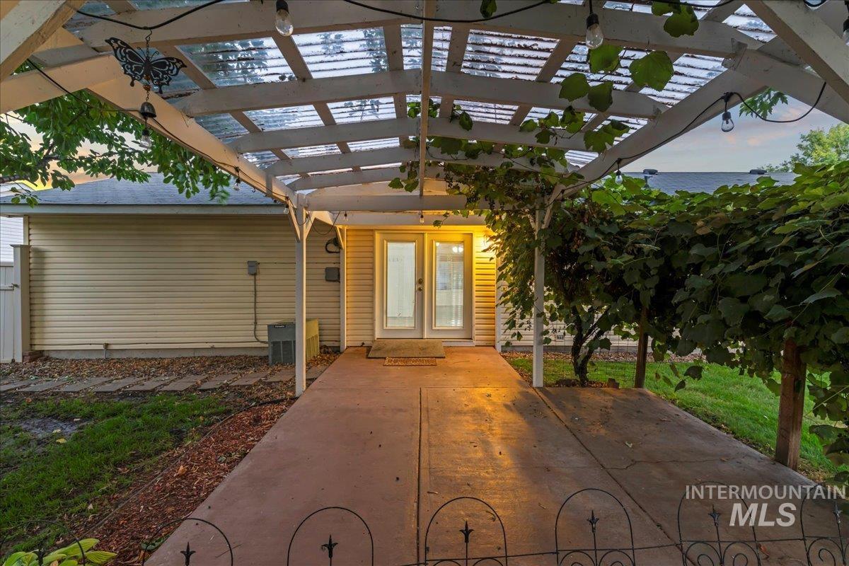 Entrance to property with a pergola and a patio area