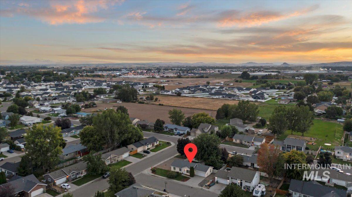 Aerial view of property's location featuring nearby suburban area
