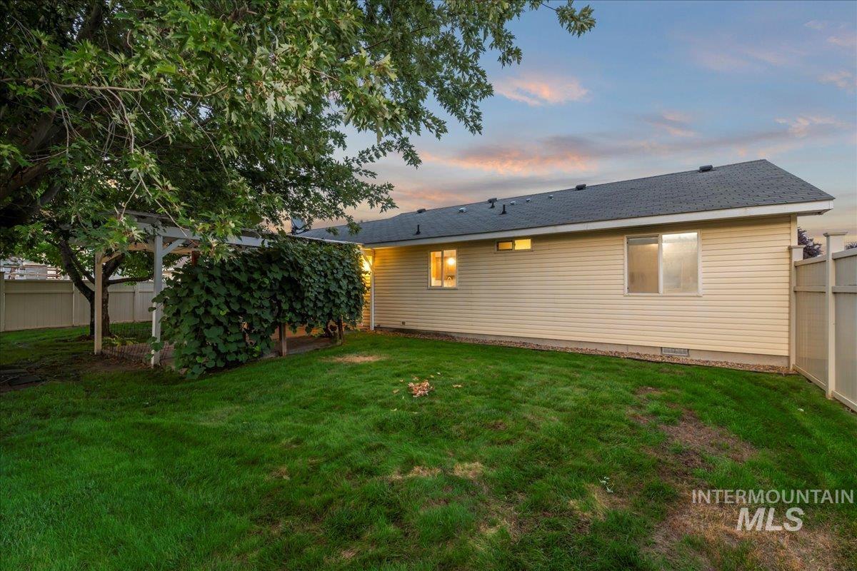 Back of property at dusk with roof with shingles