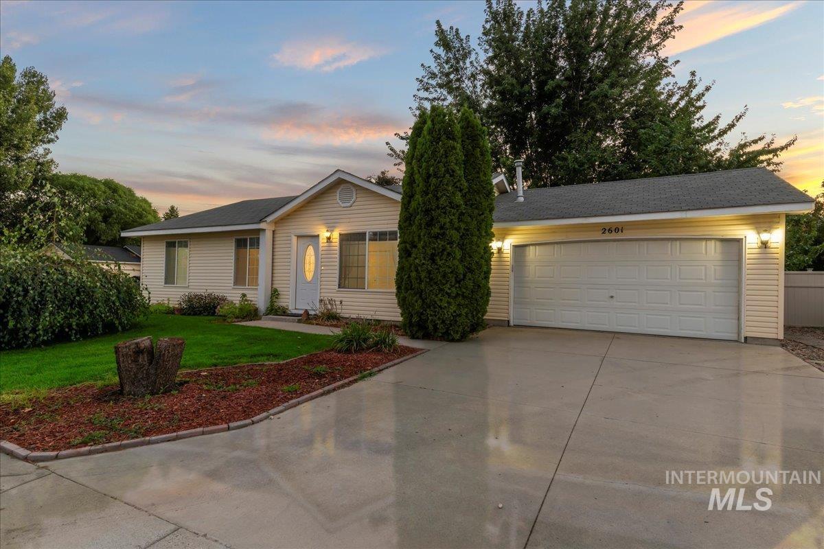 Ranch-style house with a front lawn and driveway