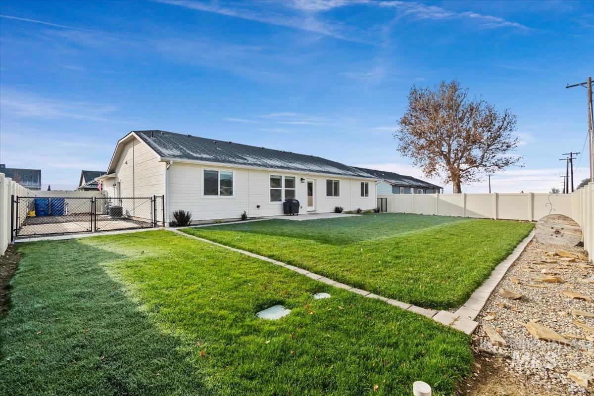 Rear view of property with a fenced backyard, a patio, and a gate