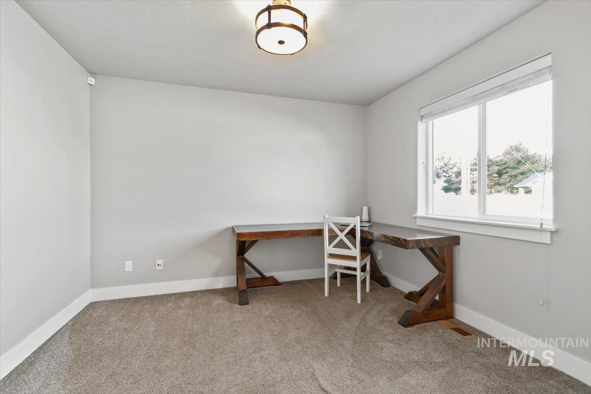 Office featuring light colored carpet and baseboards