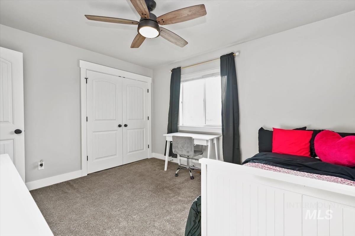 Bedroom with carpet, ceiling fan, and a closet
