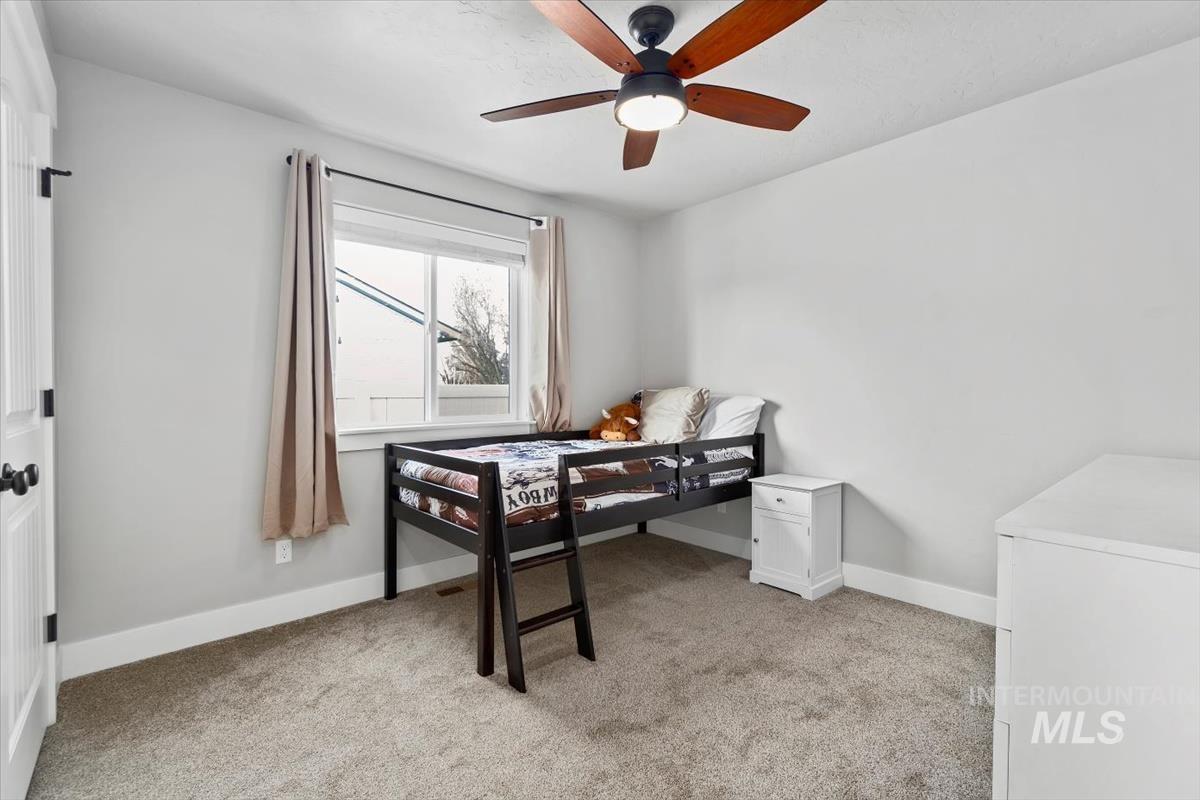 Office area featuring light colored carpet and a ceiling fan