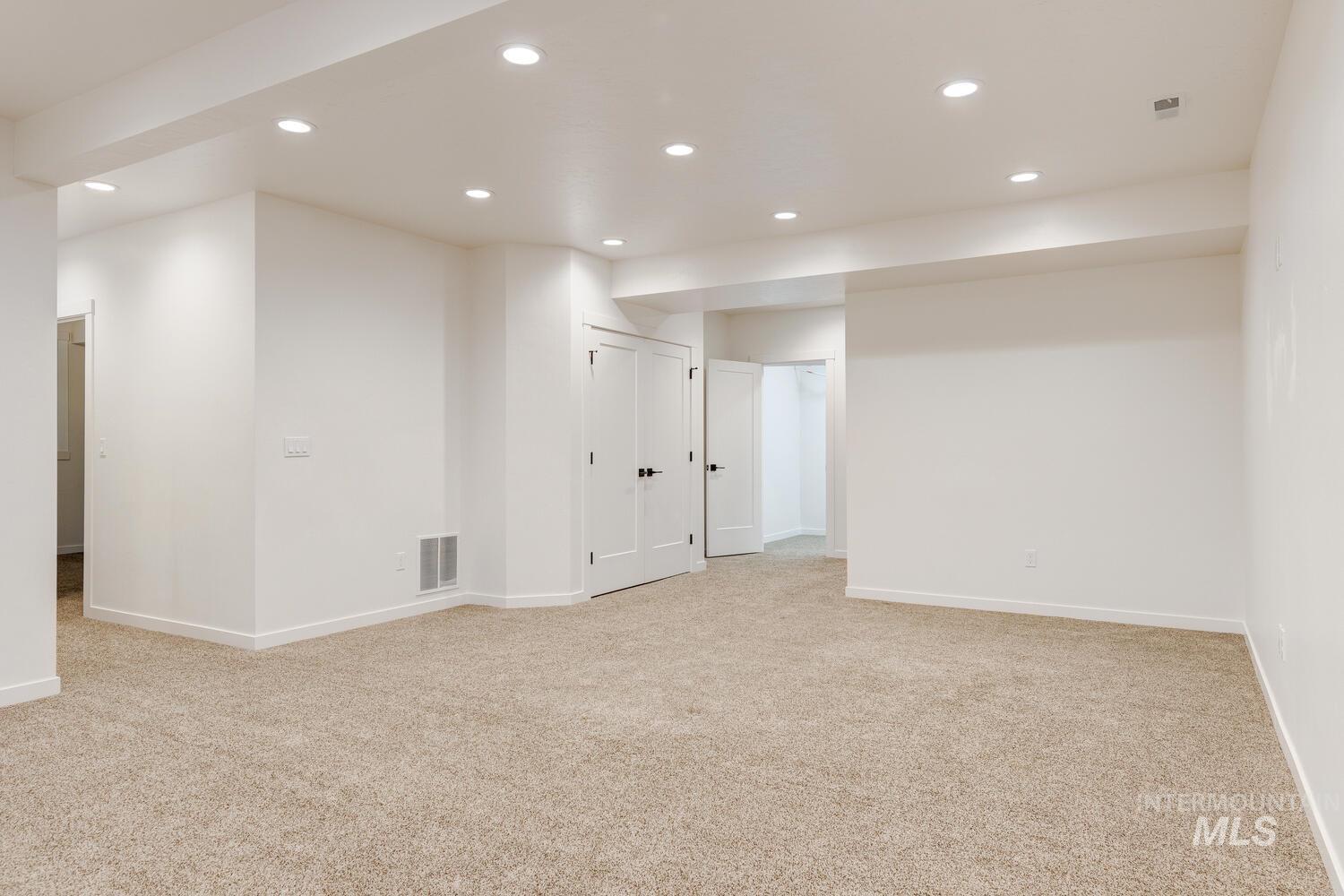 Basement with recessed lighting and light colored carpet