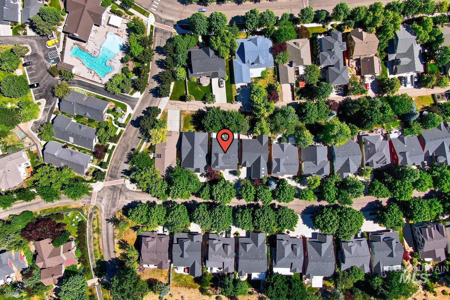 Aerial view of property and surrounding area with nearby suburban area