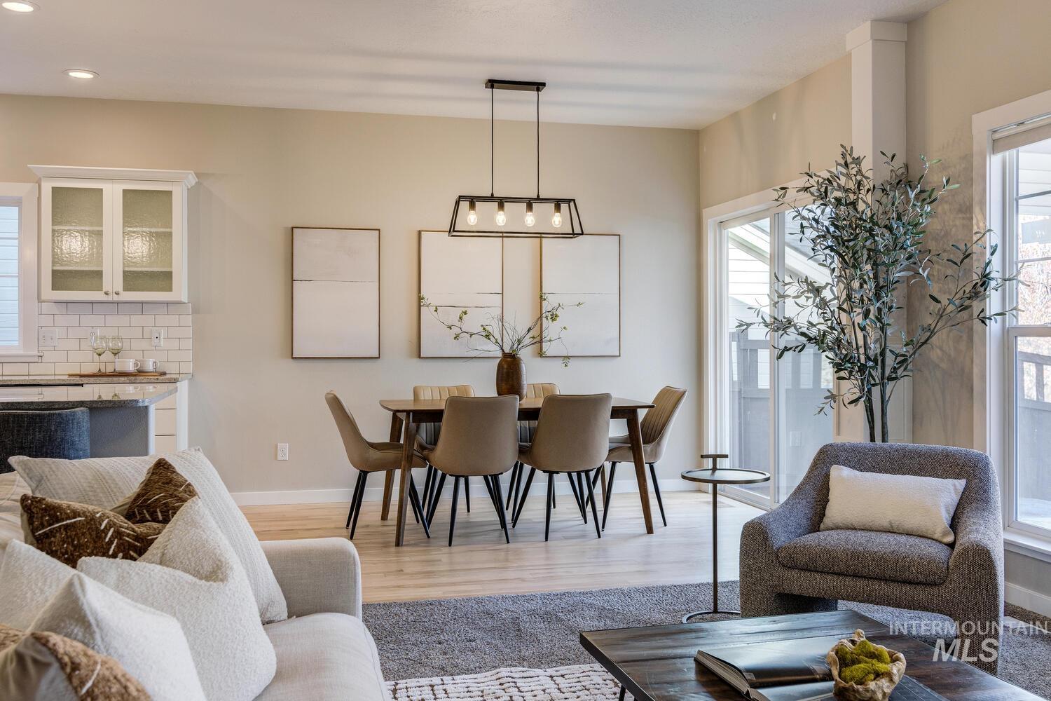 Dining room with light wood-style floors and recessed lighting