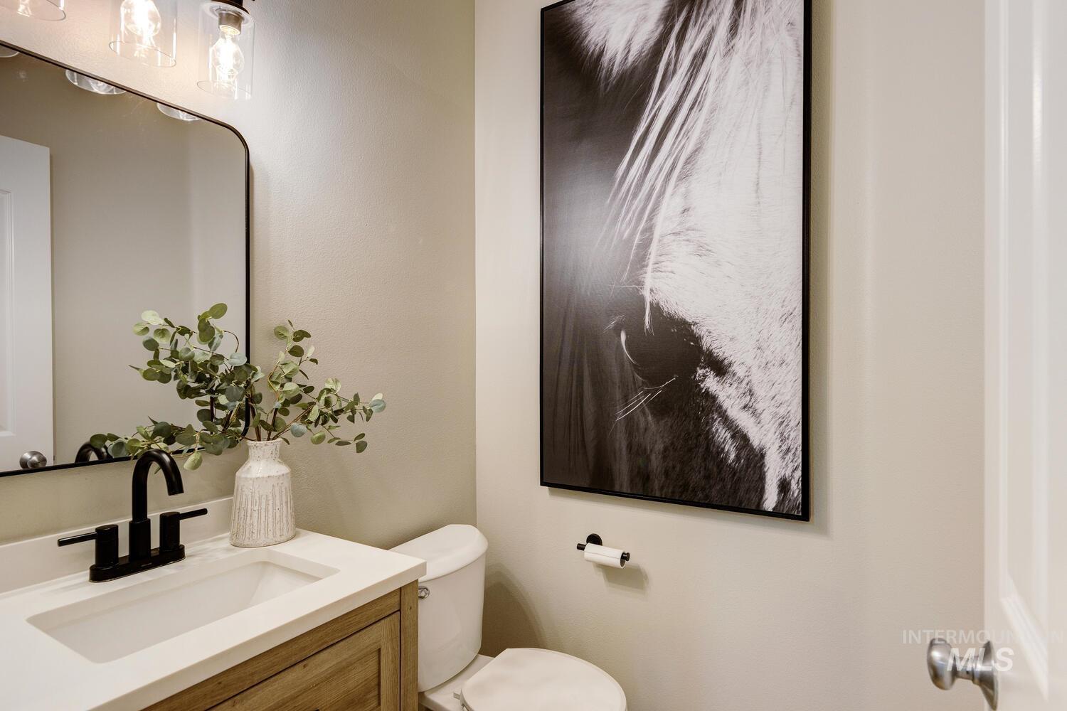 Half bath featuring vanity and toilet