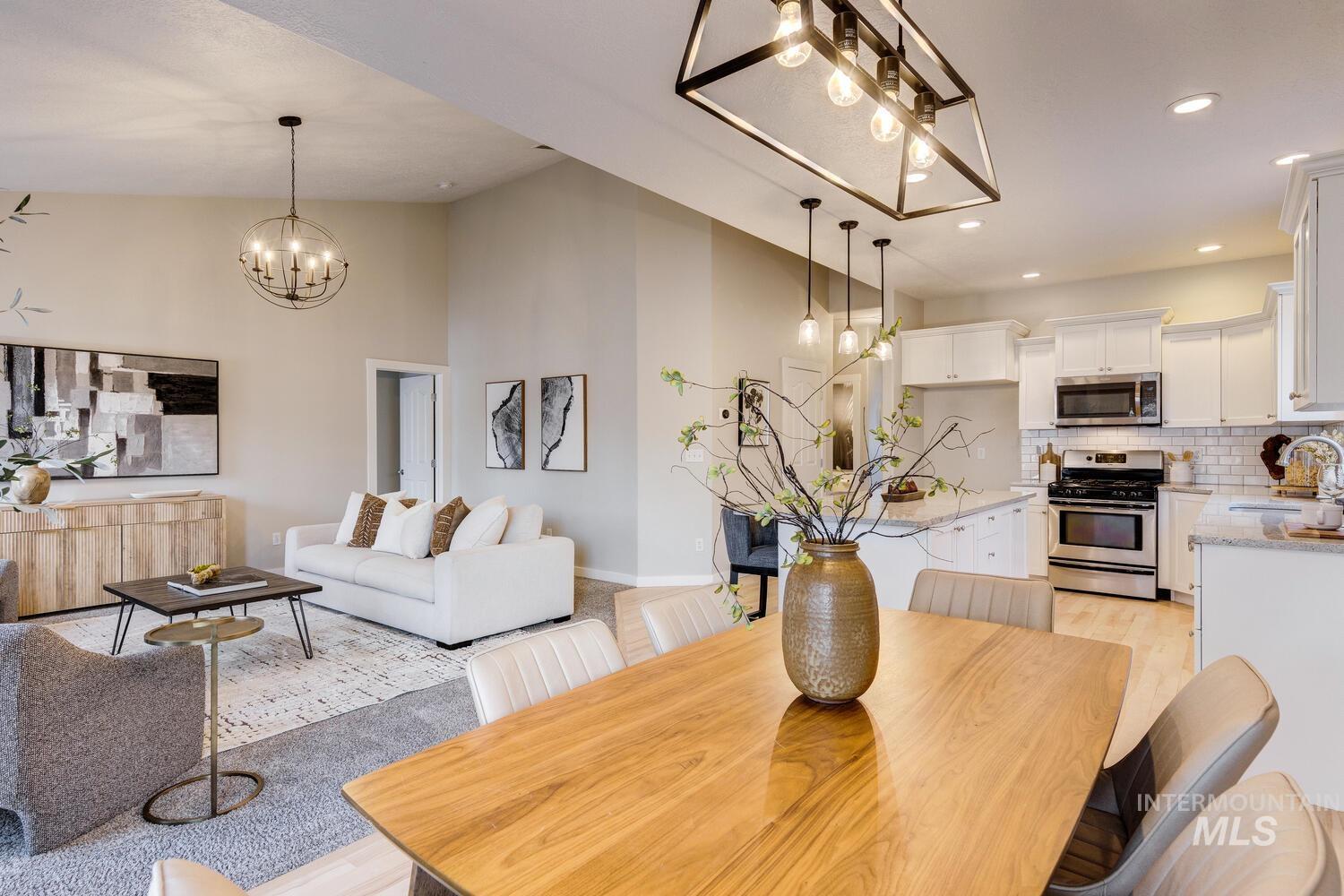 Dining area featuring a chandelier, recessed lighting, high vaulted ceiling, and light wood-style flooring