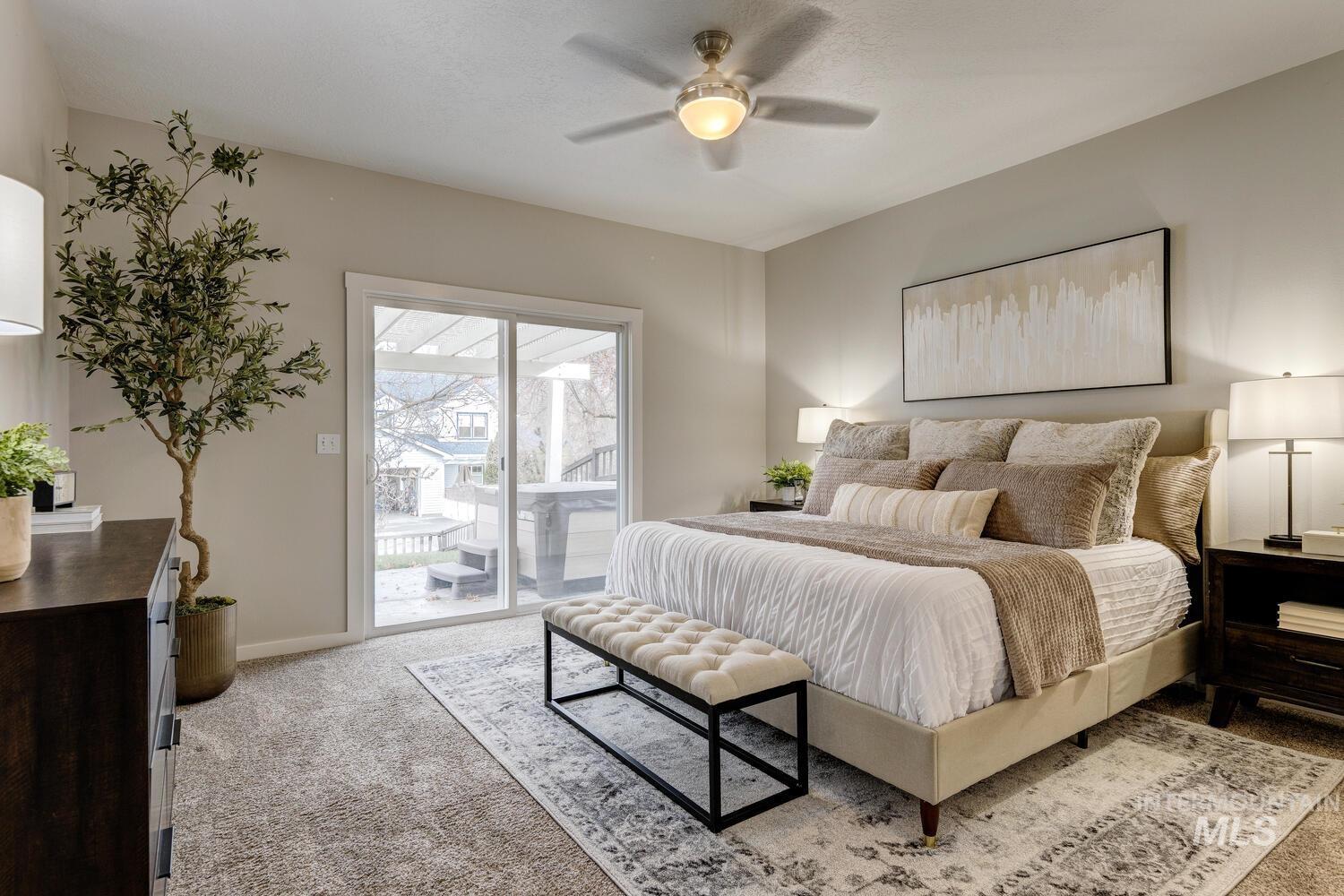 Bedroom with light colored carpet, access to exterior, and ceiling fan