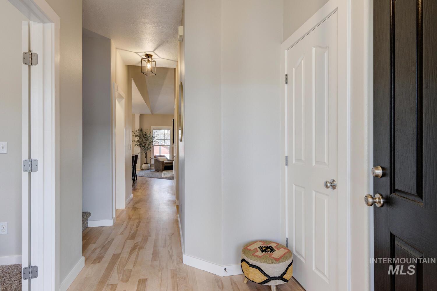 Corridor with baseboards and light wood finished floors