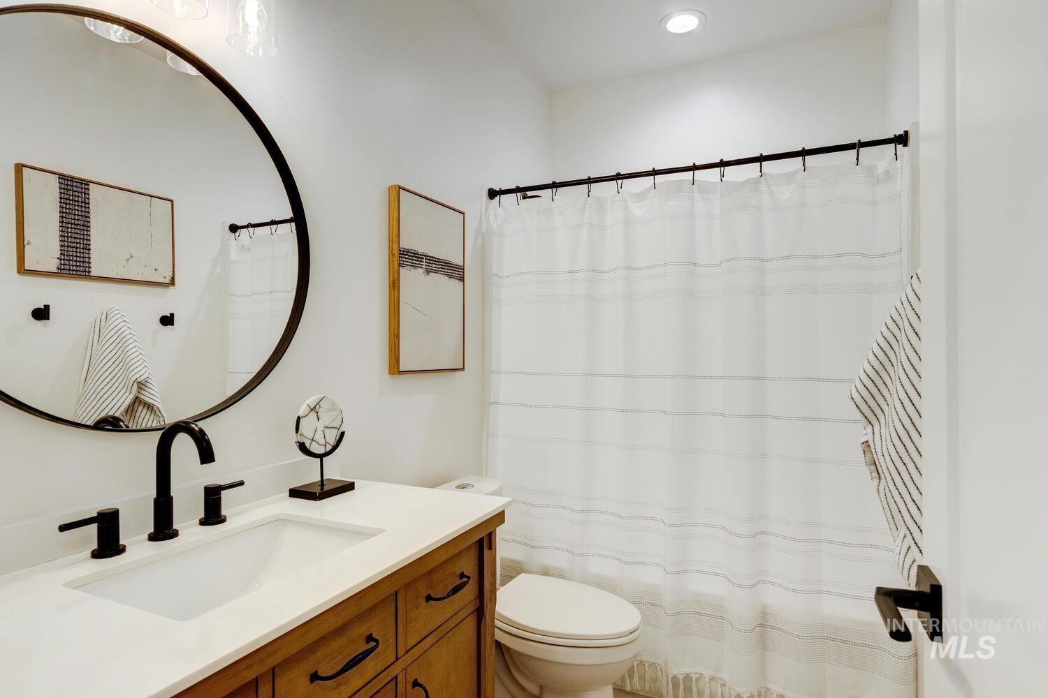 Bathroom featuring vanity and curtained shower