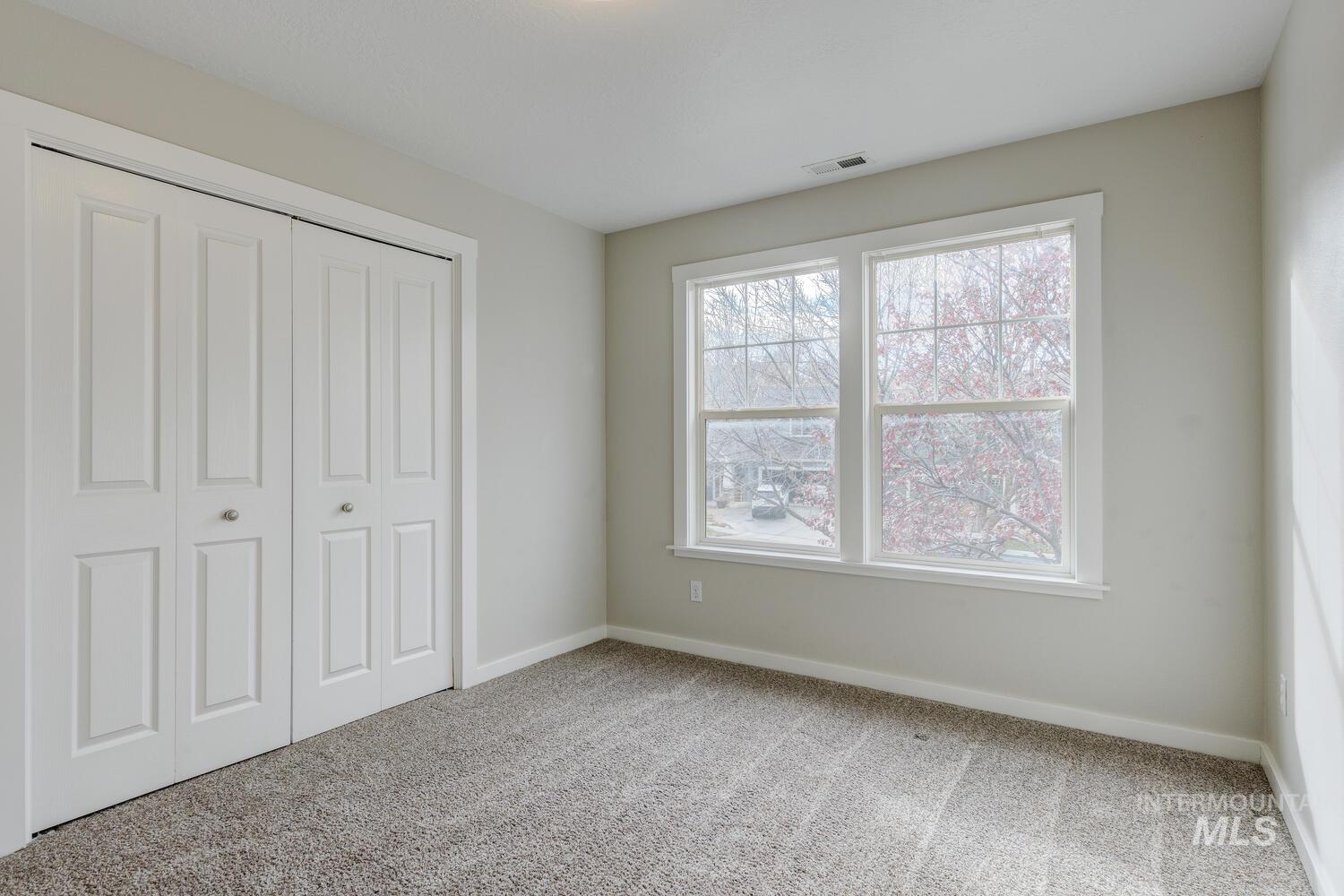 Unfurnished bedroom featuring carpet floors and a closet