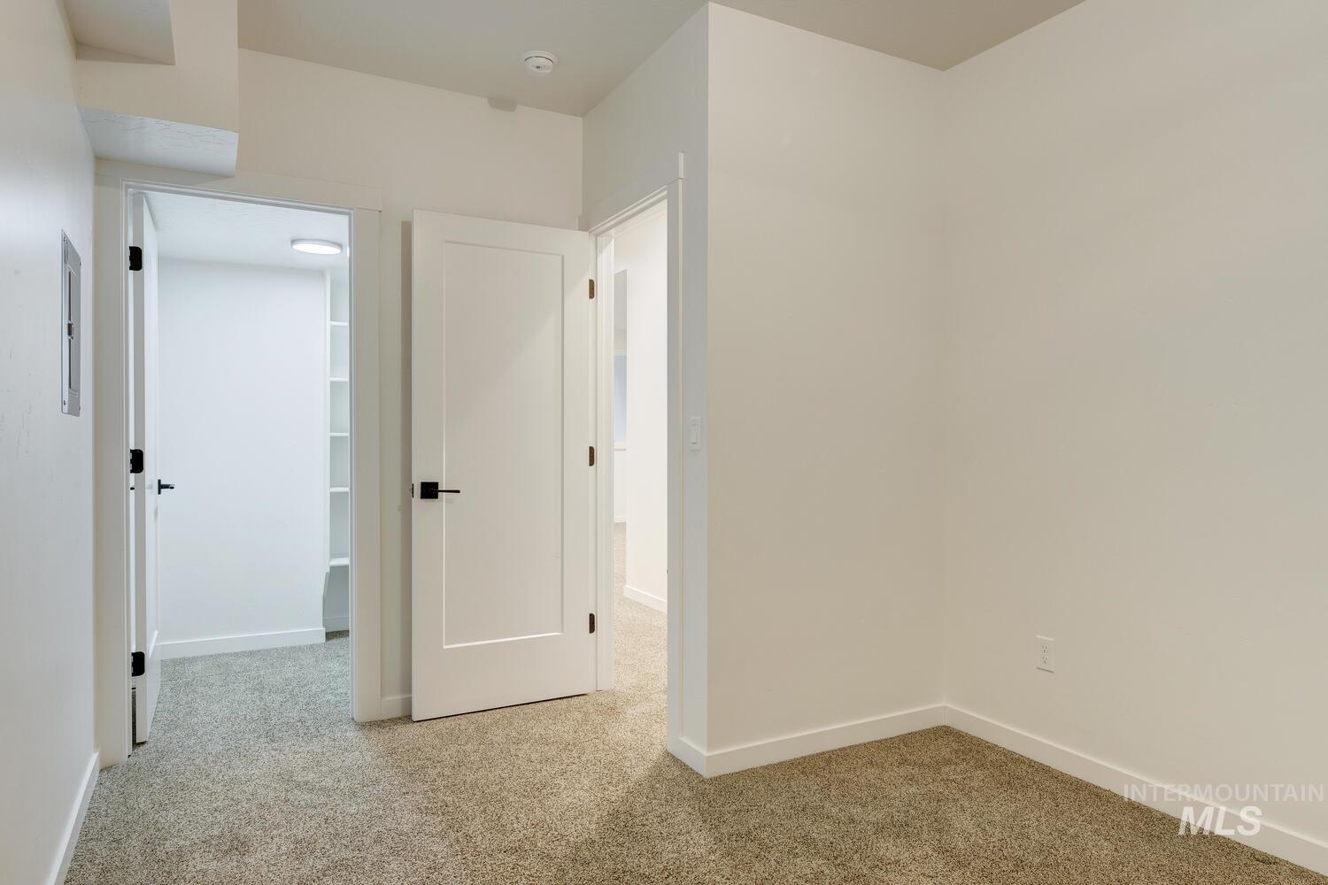 Hall with light carpet and baseboards