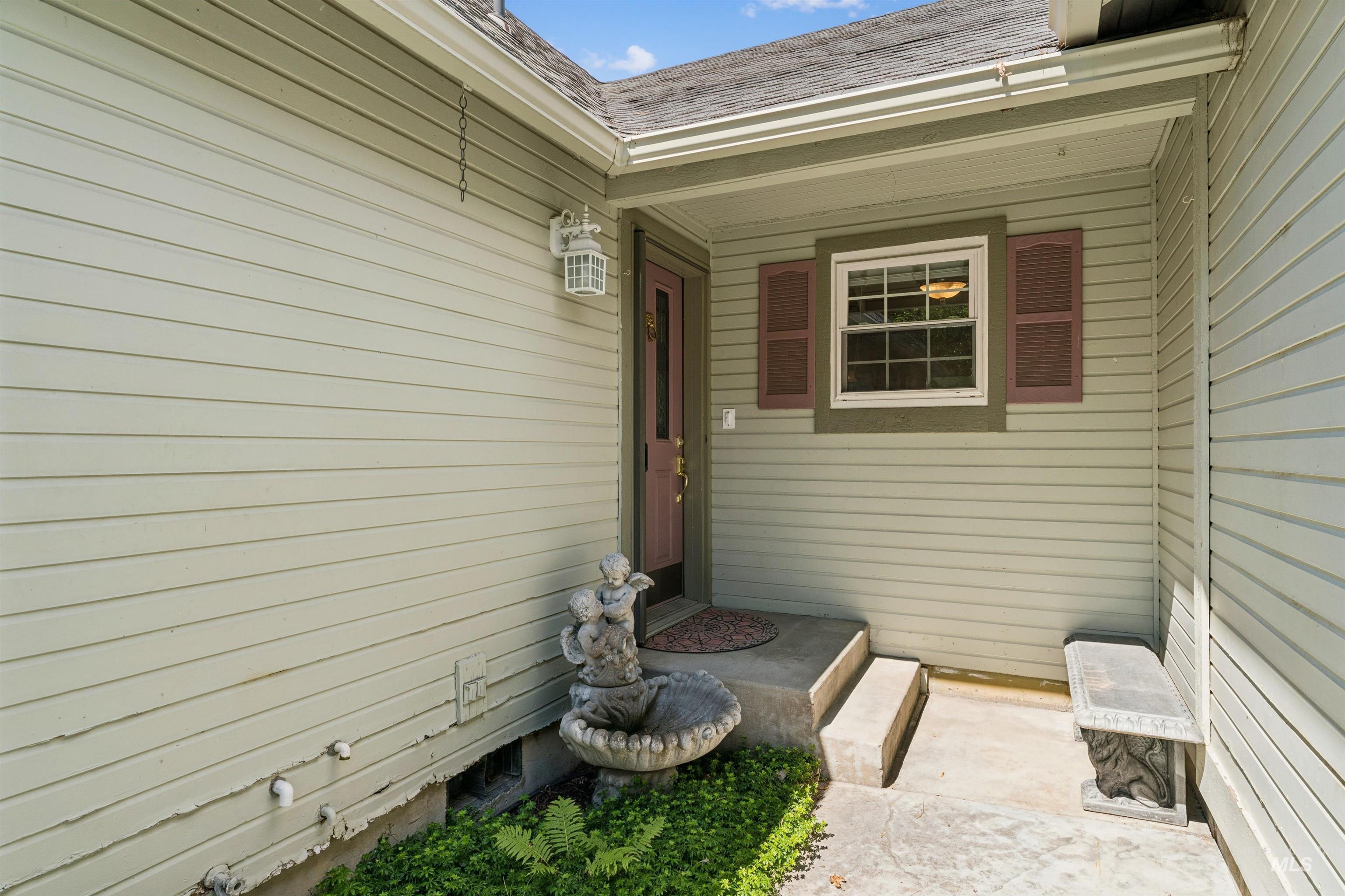Covered entry with concrete steps and landing