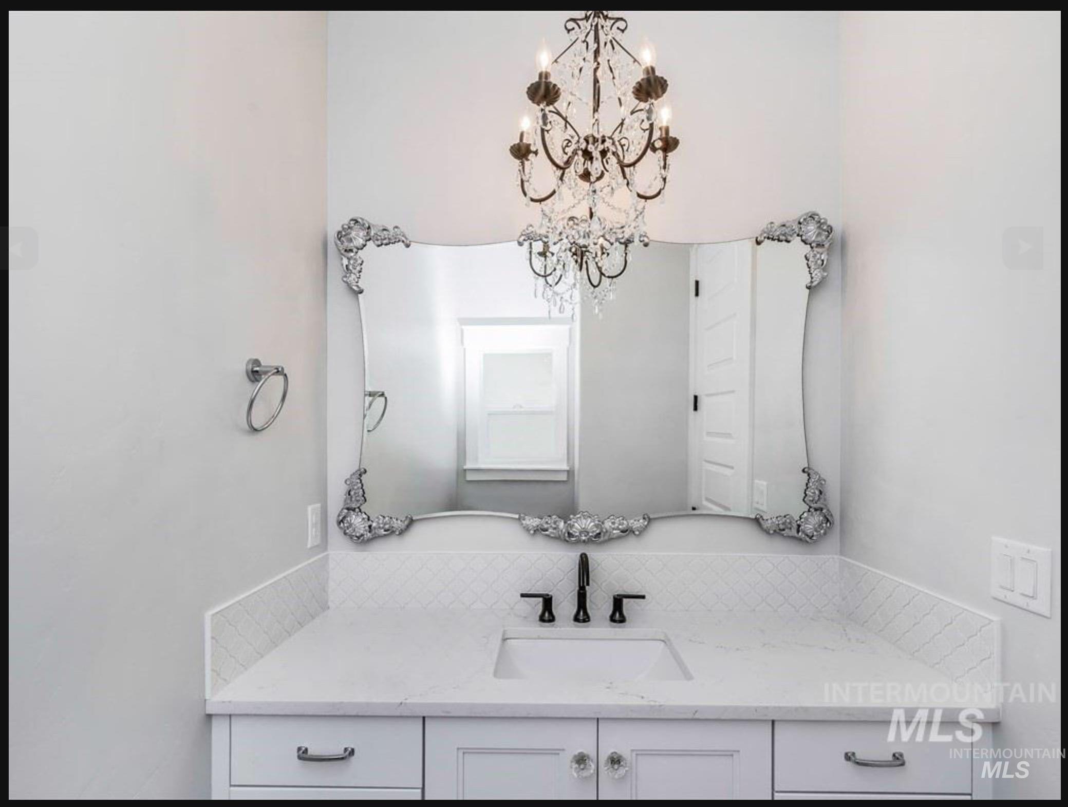 Bathroom featuring vanity and a chandelier